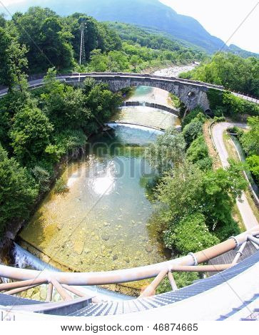 Stone Bridge Over The River In Italy