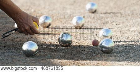 Petanque Game, Woman Measuring The Distance Of Petanque Ball In Petanque Field, Deciding Who's The W