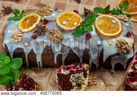 Christmas Stollen With Candied Fruit And Dried Fruits On Parchment. Stollen - Traditional German Bre