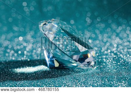 Beautiful Dazzling Diamond On Shiny Glitter Background, Closeup. Precious Gemstone