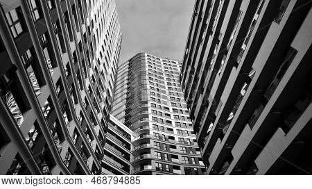 The Narrow Passage Between Modern Residential Buildings. Walls Of High-rise Apartment Buildings And 