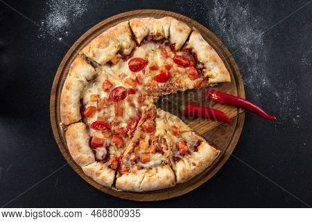 Indian Pizza With Tomatoes And Peppers Close-up View. Traditional Indian Food Pizza On Bread Flatbre