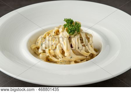 Freshly Made Fettucini Alfredo On A White Porcelain Plate