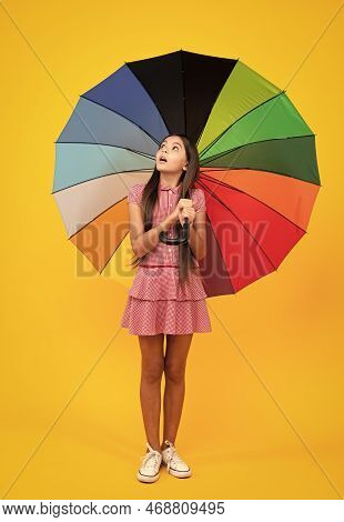 Shocked Surprised Teenager Girl. Summer Dress. Happy Teen Girl Holding Rainbow Umbella Standing Isol