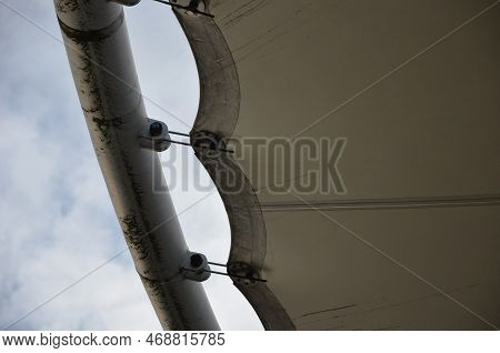 White Tarpaulin Taut, Shading From The Sun And Rain Over The Terrace Of The Restaurant, On The Playg