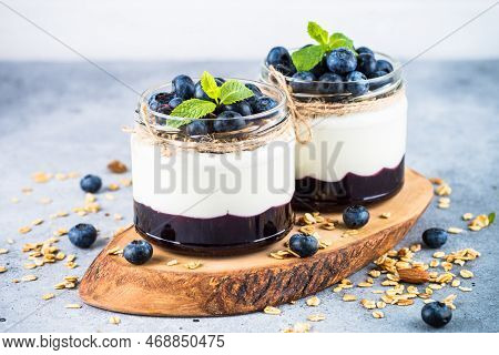 Parfait With Blueberry, Granola And Jam In Two Glass Jars. Healthy Dessert Or Snack.