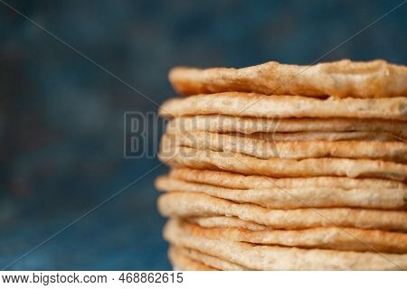 Flatbread Lavash, Chapati, Naan, Heap Of Tortilla On A Blue Background Homemade Flatbread Stacked.