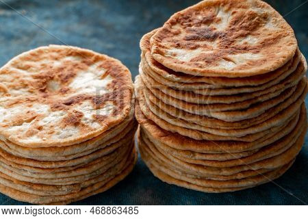 Flatbread Lavash, Chapati, Naan, Heap Of Tortilla On A Blue Background Homemade Flatbread Stacked.