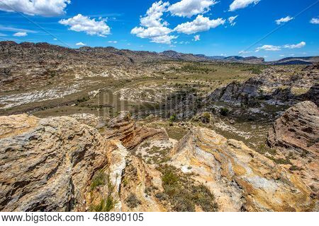 Isalo National Park In Ihorombe Region. Wilderness Landscape With Water Erosion Into Rocky Outcrops 