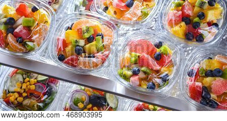 Boxes With Pre-packaged Fruit Salads In A Commercial Fridge