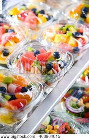 Boxes With Pre-packaged Fruit Salads In A Commercial Fridge