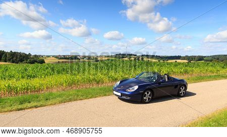 Schopfloch, Germany - July 31, 2021: Blue Roadster Porsche Boxster 986 With Corn Field Panorama At R