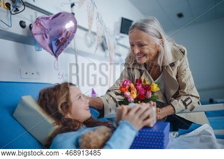 Granmother Visiting Her Sick Granddaughter In Hospital, Celebrating Her Birthday.