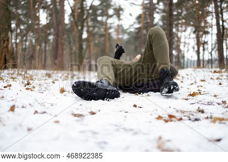 Young Man Slipped And Lost His Balance During A Walk On A Birch Grove In Winter.