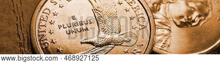 American Coins Close-up Lie On Dark Surface Of Table. Soaring Eagle Sacagawea Dollar Coin. Us Econom