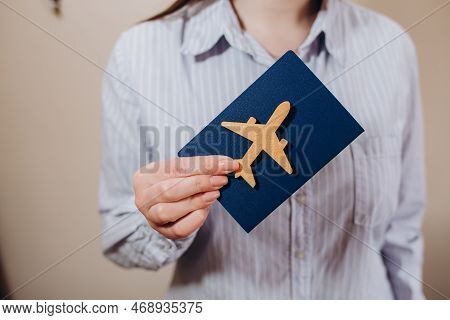 The Travel Agent Keeps Tickets For The Plane In The Travel Agency. She Offers Them To Clients. Coupl