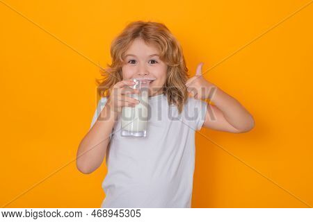 Dairy Milk. Child With A Glass Of Milk. Cute Boy In White Shirt Holding Glass Of Milk On Yellow Isol