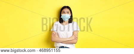 Covid, Health Care And Pandemic Concept. Asian Woman In White T-shirt And Medical Mask Cross Arms On