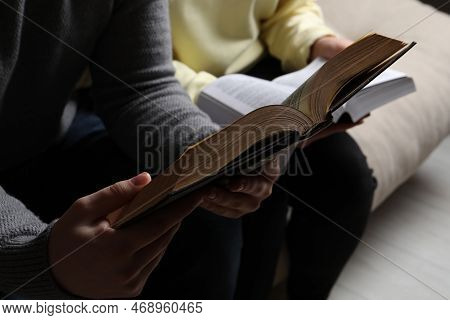 Couple Sitting And Reading Holy Bibles, Closeup