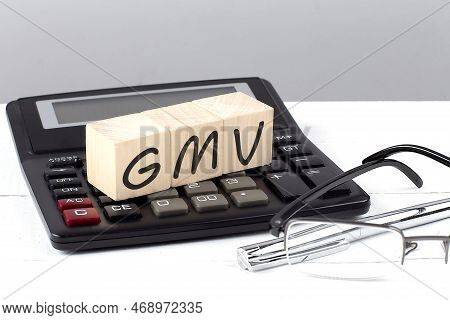 Gmv Concept On A Wooden Cubes On Calculator On White Background