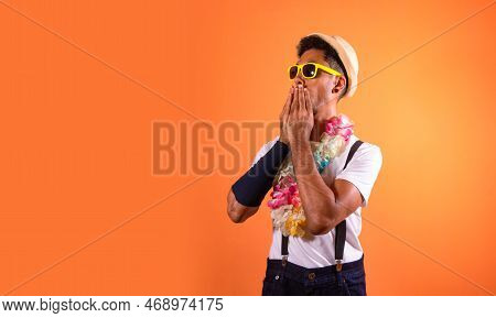 Portrait Of Black Man With Carnival Props Isolated On Orange Background.