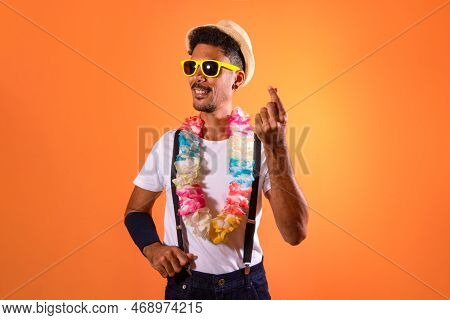 Portrait Of Black Man With Carnival Props Isolated On Orange Background.