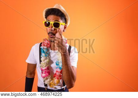 Portrait Of Black Man With Carnival Props Isolated On Orange Background.