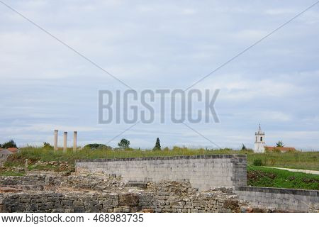 Ruins Of The Old Roman City Of Conimbriga In Portugal With A Medieval Church In The Background