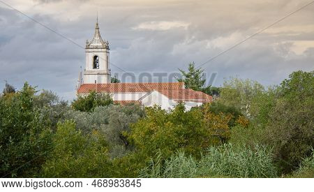 Ruins Of The Old Roman City Of Conimbriga In Portugal With A Medieval Church In The Background