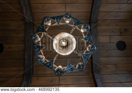 Medieval Style Chandelier Glows Bright While Hanging Over Head
