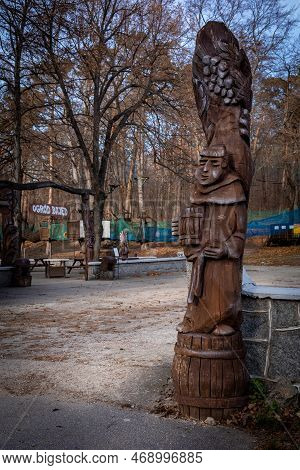 Sobotka, Poland - December 31, 2022: A Monk Holding A Barrel Of Beer. Folk Wooden Sculpture In Front