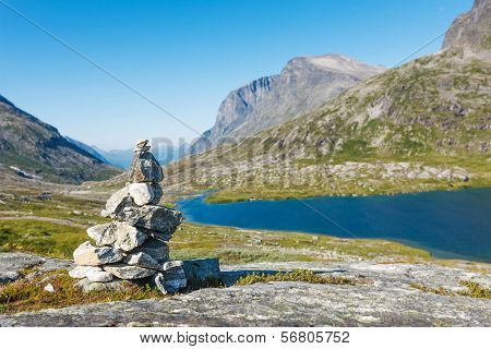 Stack of rocks with mountain and lake view
