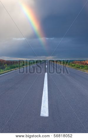 Driving Om Empty Road Under The Rainbow