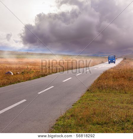 Oncoming Storm And Truck On The Road