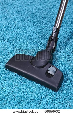 Vacuuming carpet in house