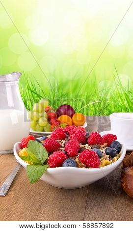 Fresh healthy food on wooden table, with green background