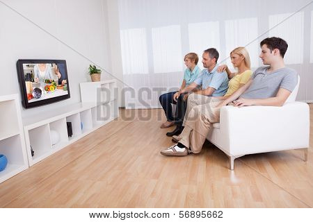 Family Watching Widescreen Television