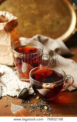 Beautiful vintage composition with herbal tea, on wooden table