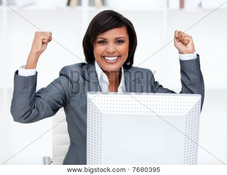 Confident Businesswoman Punching The Air In Celebration