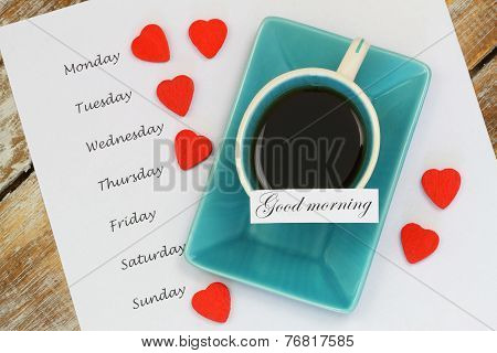 Good morning card with cup of tea and days of the week listed on white paper