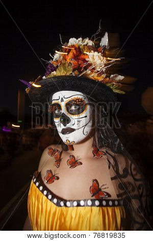 Woman In Dia De Los Muertos Makeup With Butterflies