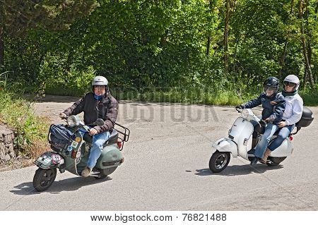 Bikers Riding Vintage Italian Scooter Vespa