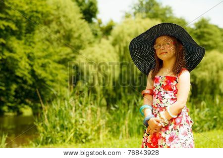 Cute Little Girl In Big Hat Pretending To Be Lady