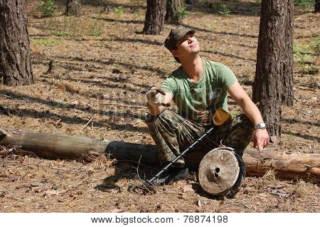 Kiev,Ukraine.June 3.Military archeology. Man with metal detector and German WWII anti tank landmine.At June 3,2012 in Kiev, Ukraine 