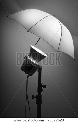Detail of studio flash strobe light and umbrella on stand strobist professional photographer