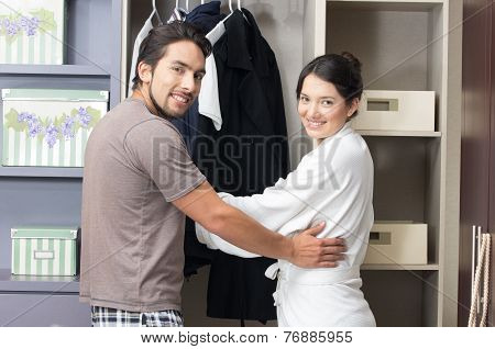 married young couple posing in the closet