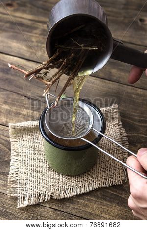 Woman Pouring Freshly Infused Tea