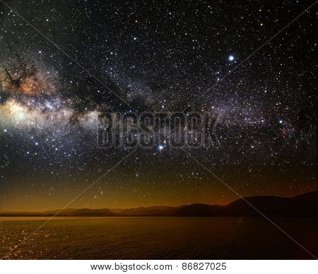 month on a background star sky reflected in the sea. Elements of this image furnished by NASA