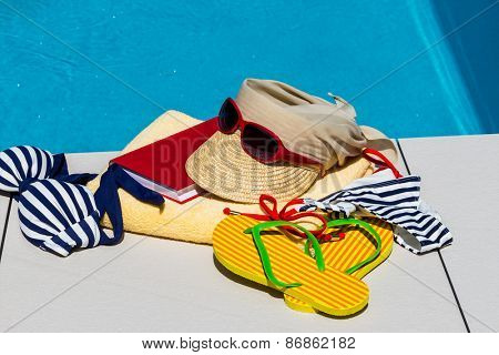 utensils for a nice relaxing vacation day lying next to a swimming pool. relaxation on vacation.