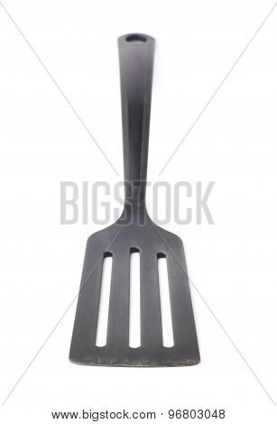 Used black plastic spatula isolated